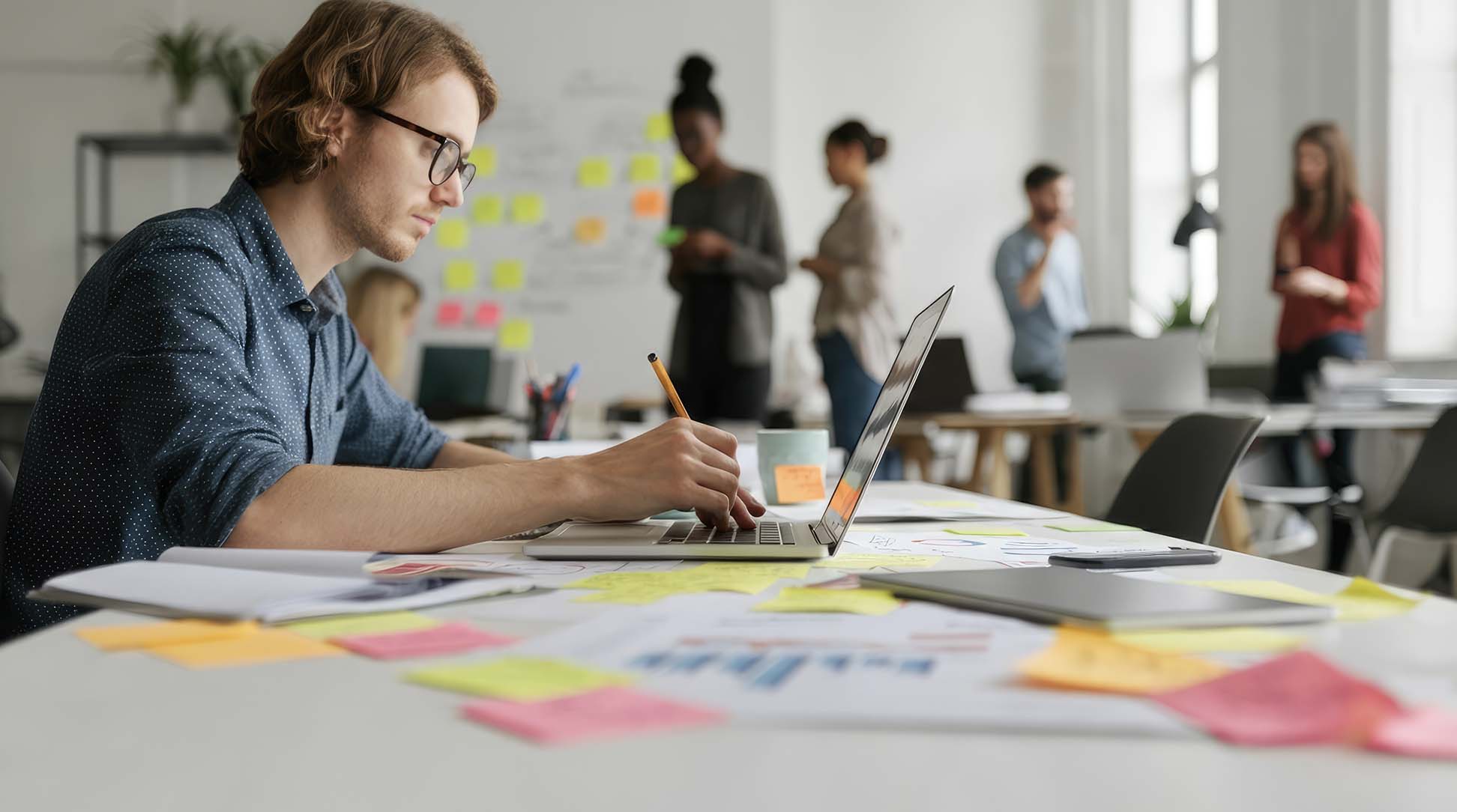 Professional planning SASE adoption strategy with laptop and team collaboration.